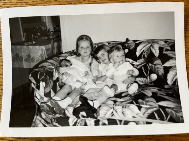 Photo of Joan and I sitting on a couch with her baby brother.