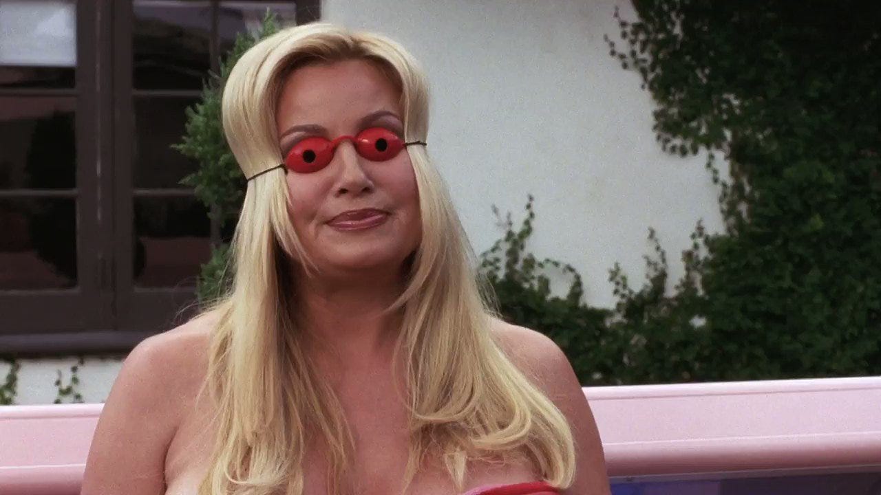 Jennifer Coolidge in A Cinderella Story emerging from a tanning bed with eye covers