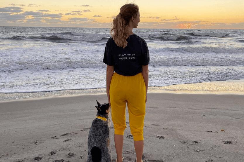 Scout the Australian cattle dog watching the sunrise while sitting next to her owner on the dog-friendly stretch of Cocoa Beach on Florida's Space Coast