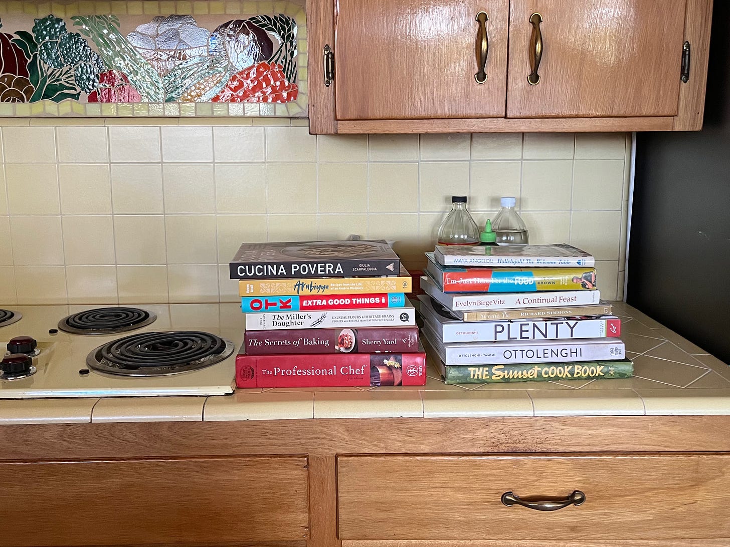 my kitchen counter with two stacks of cookbooks