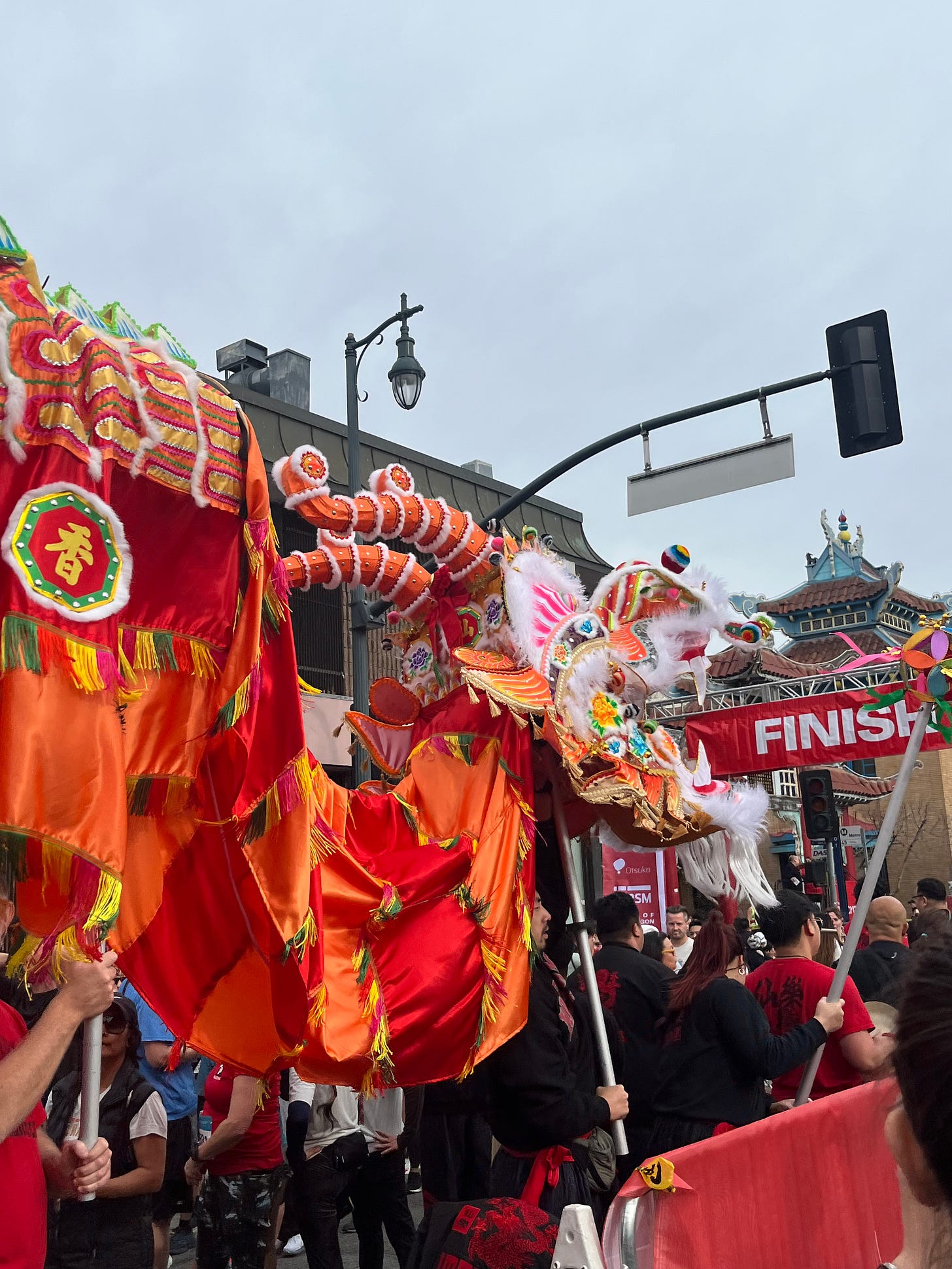 A dragon dancer at the finish line of a race.