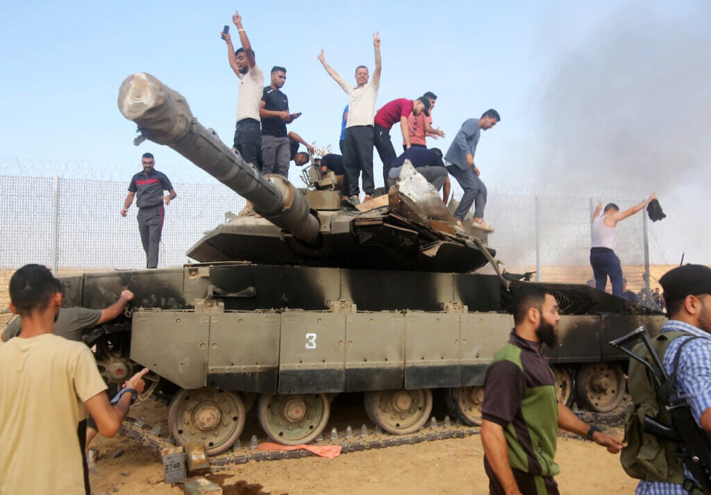 Palestinians take control of an Israeli tank after crossing the border fence with Israel from Khan Yunis in the southern Gaza Strip on October 7, 2023. (Photo: Stringer/ APA Images) Palestinians take control of an Israeli tank after crossing the border fence with Israel from Khan Yunis in the southern Gaza Strip on October 7, 2023. (Photo: Stringer/ APA Images)