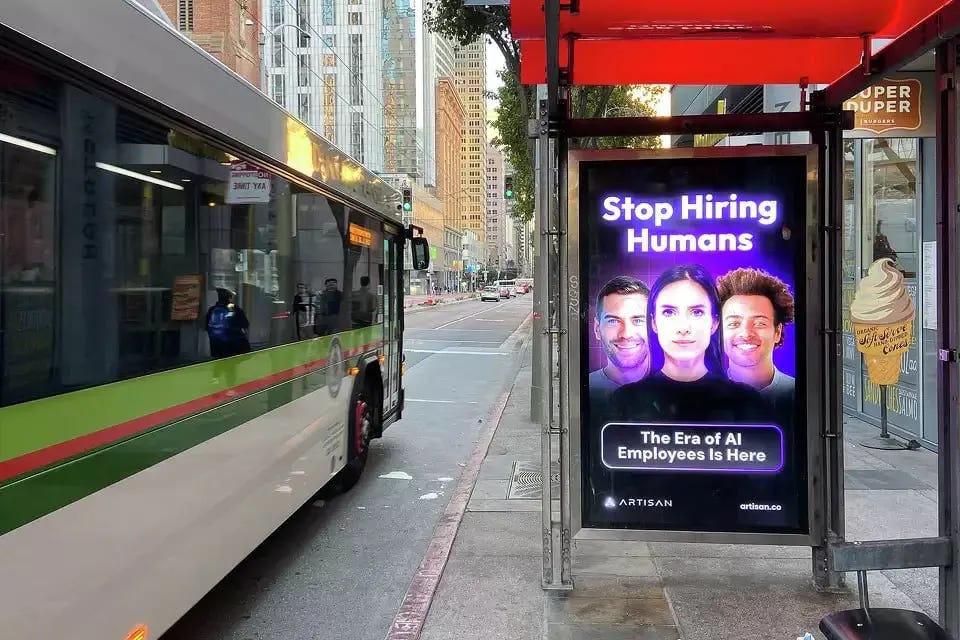 A street in San Francisco showing a sign that says "Stop Hiring Humans"