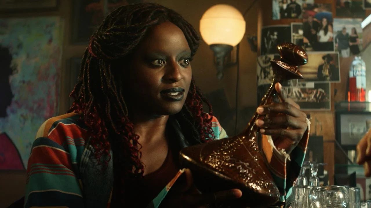 This image shows Young Guinan (played by Ito Aghayere) holding the ancient El-Aurian bottle over which her species established a truce with the Q Continnum. This image shows Young Guinan (played by Ito Aghayere) holding the ancient El-Aurian bottle over which her species established a truce with the Q Continnum.