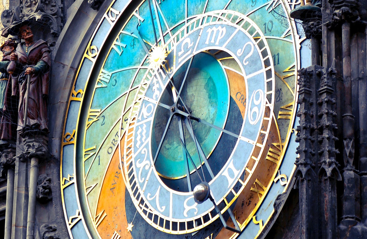 An elaborate, multicolored clock, set into a baroque cathedral.