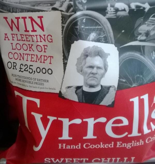 A red bag of crisps with white lettering and a picture of a scowling clergyman next to a panel which says 'Win a Fleeting Look of Contempt or £25,000'