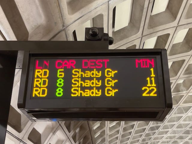 a metro sign showing train destinations and arrival times in a Washington, DC metro station.