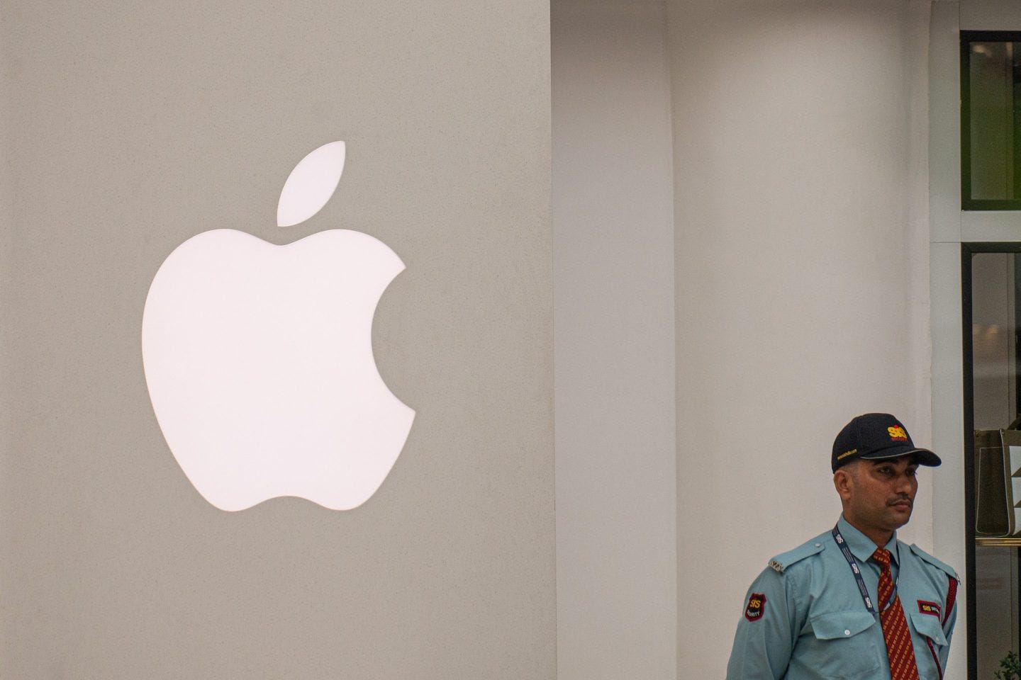 A security guard stands outside a recently opened Apple store in New Delhi.