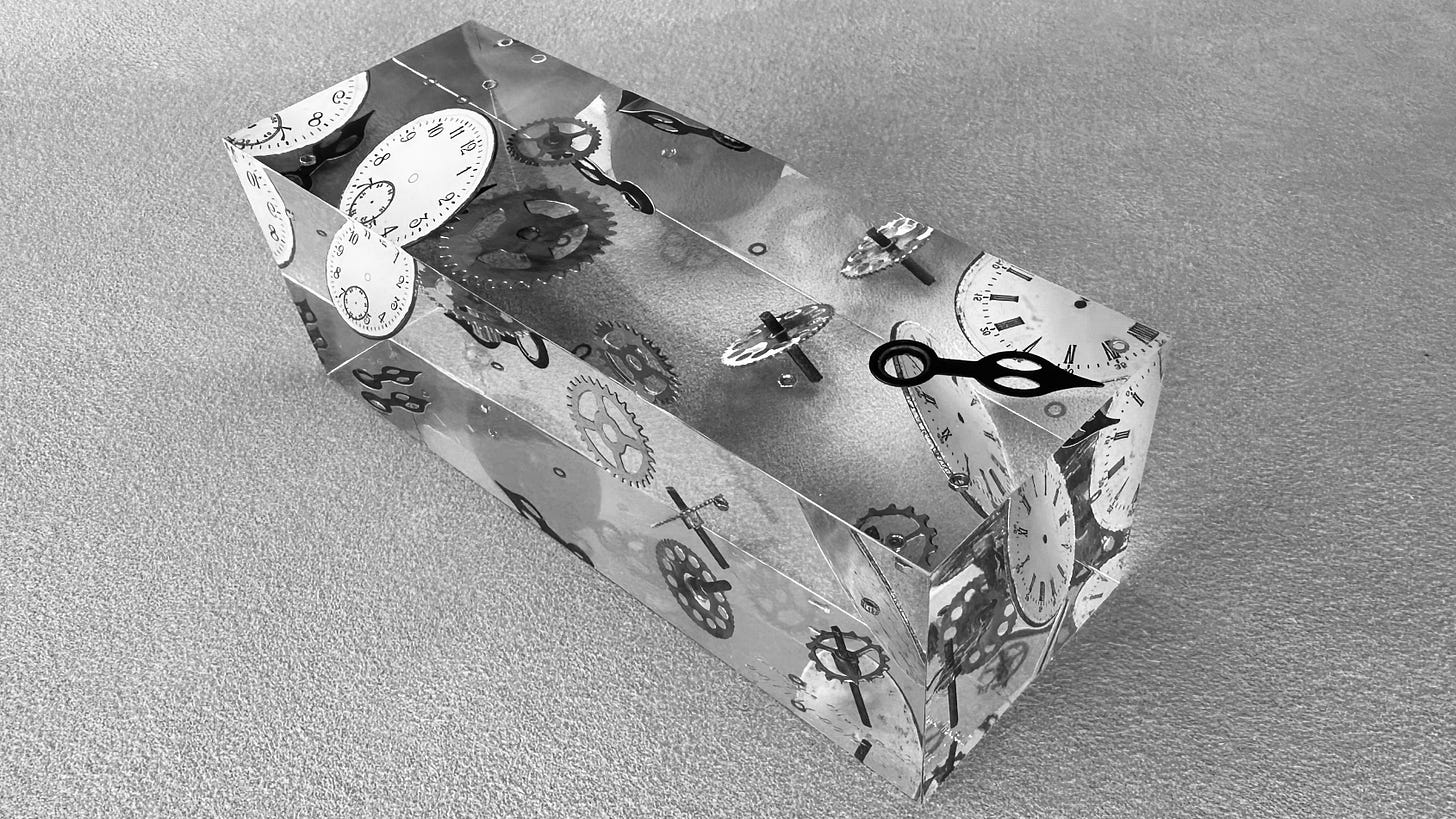 Photo of components of a mechanical clock embedded in a block of transparent material.