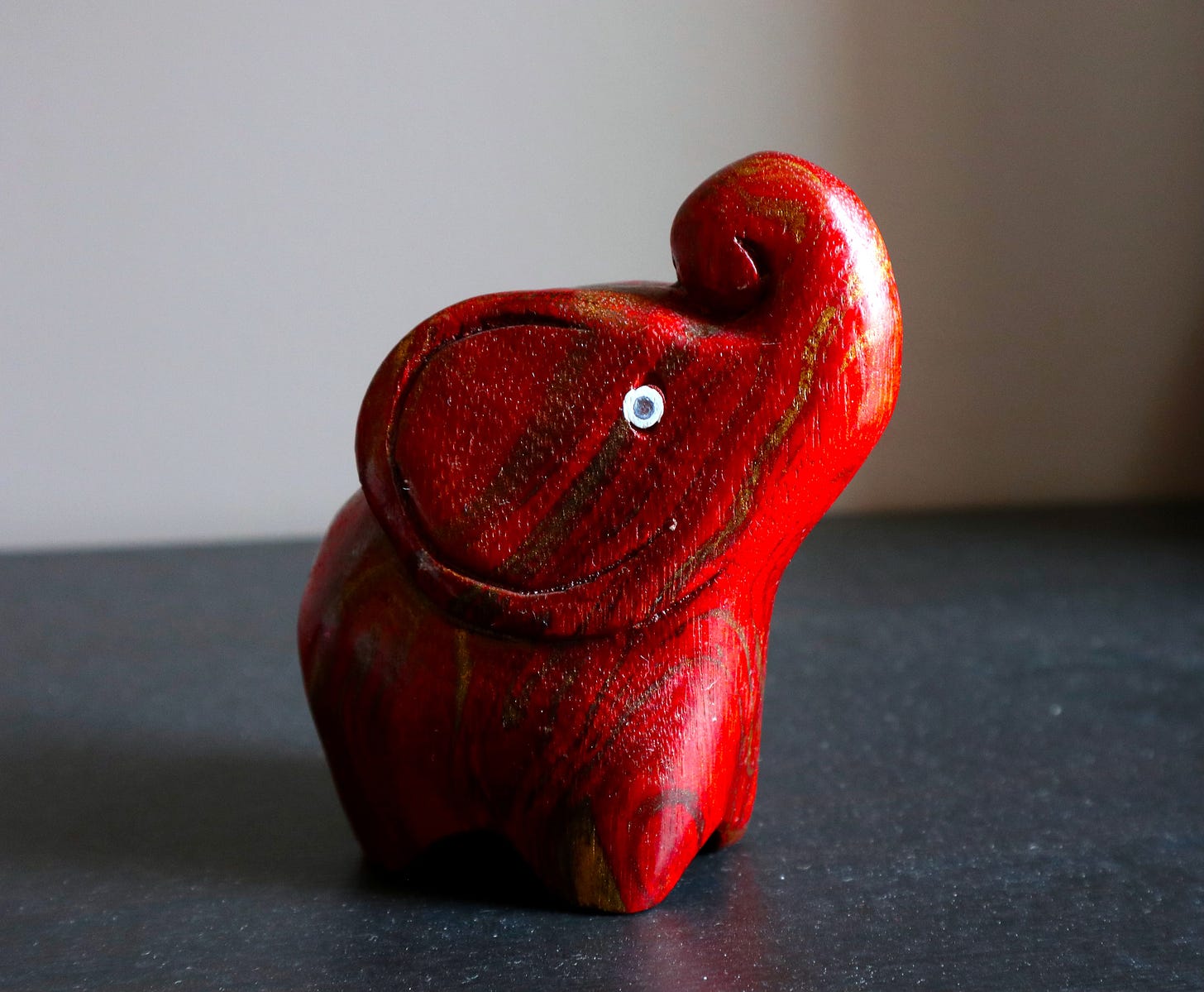 a red elephant made of wood