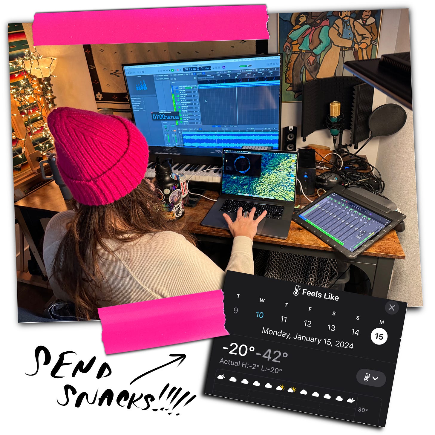 woman in hot pink beanie sits in front of multiple computer screens working at a DAW, pink tape attaches a weather report saying Feels Like -42, written by hand it says, "send snacks!!!!"