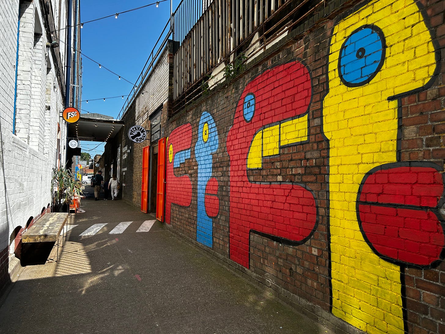 Street art lining the walls of a lane way in Peckham, London.