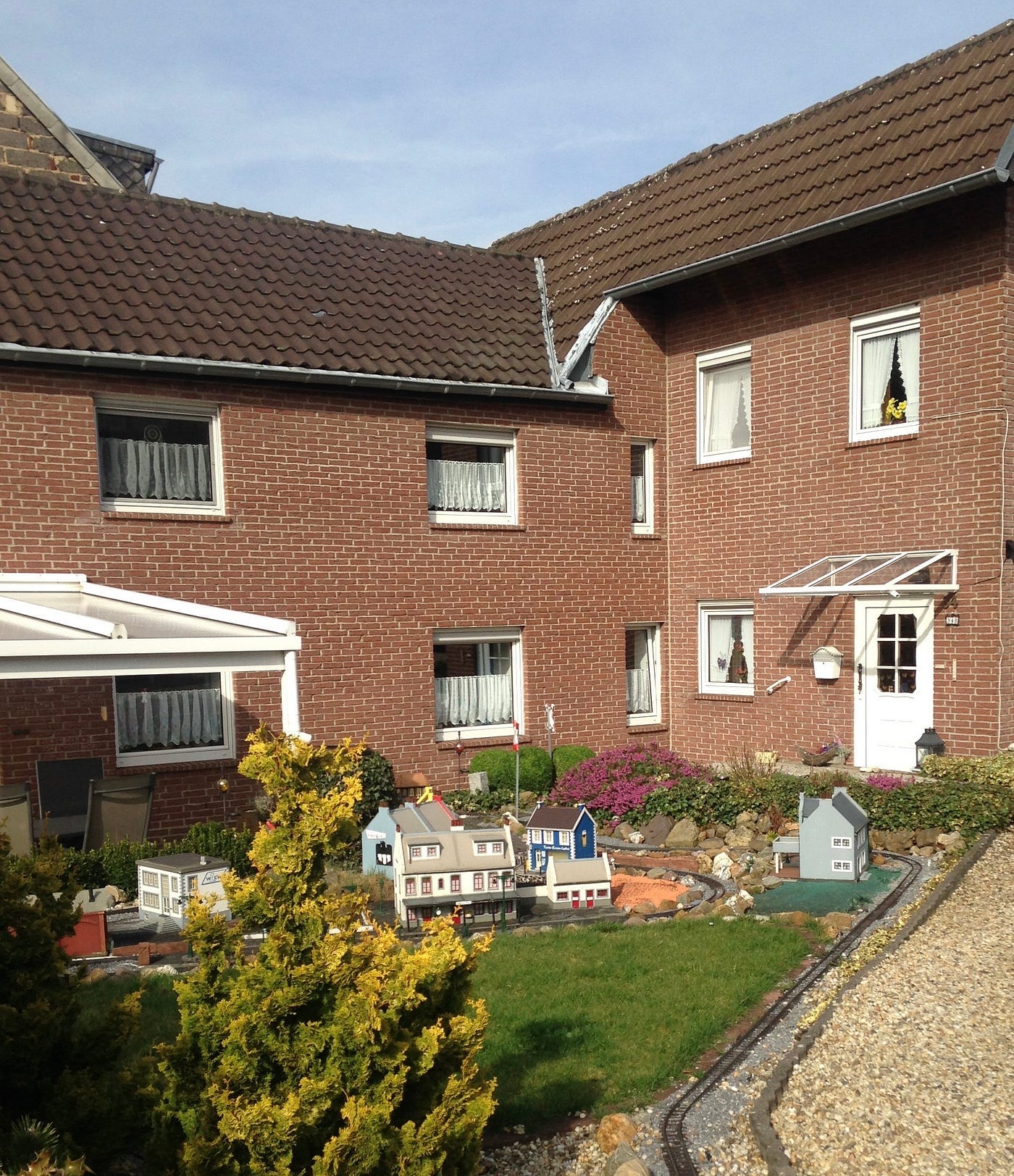 A house in Herzogenrath, Germany with a train set in the yard.