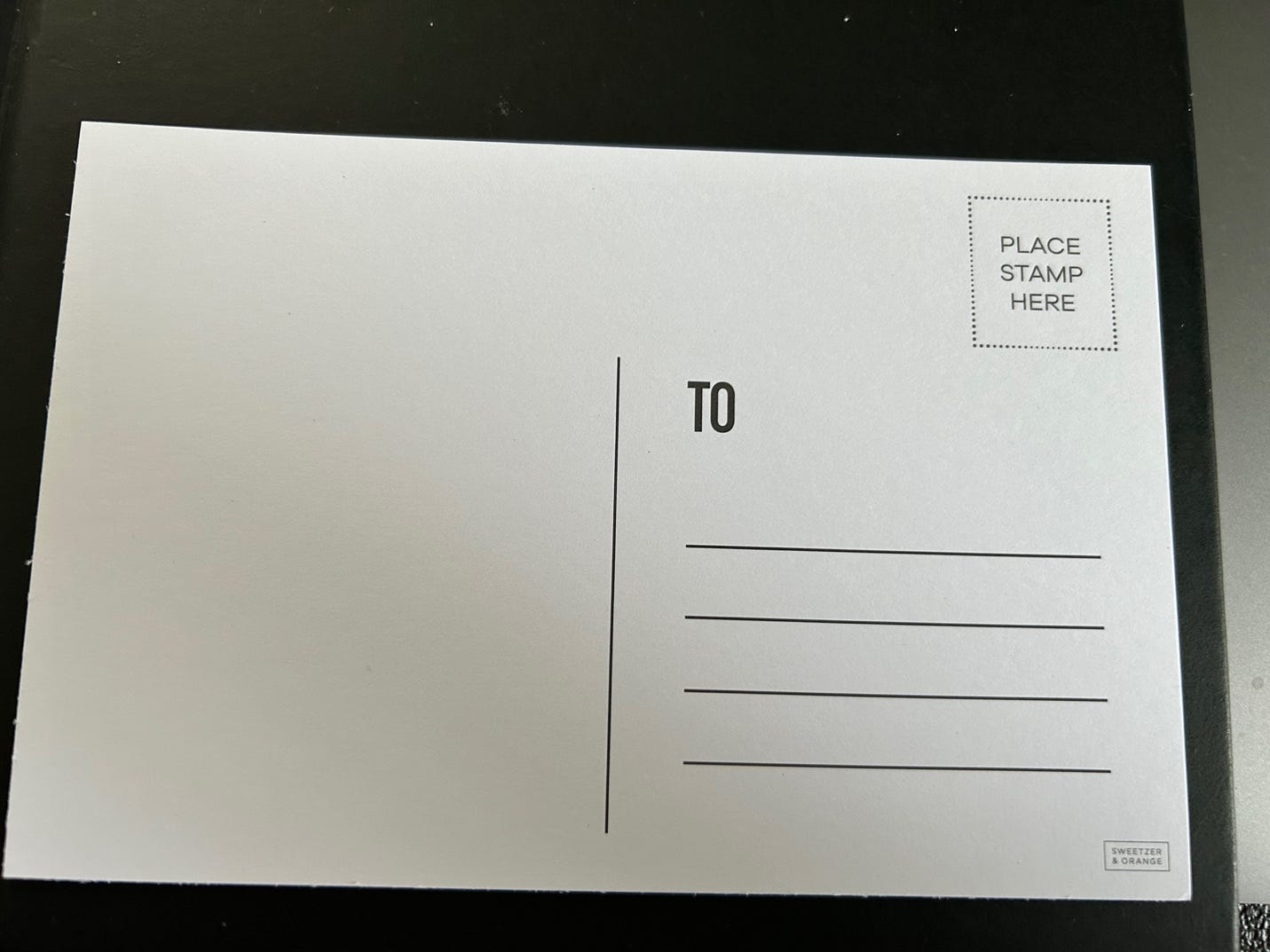 A white postcard with black text

Description automatically generated