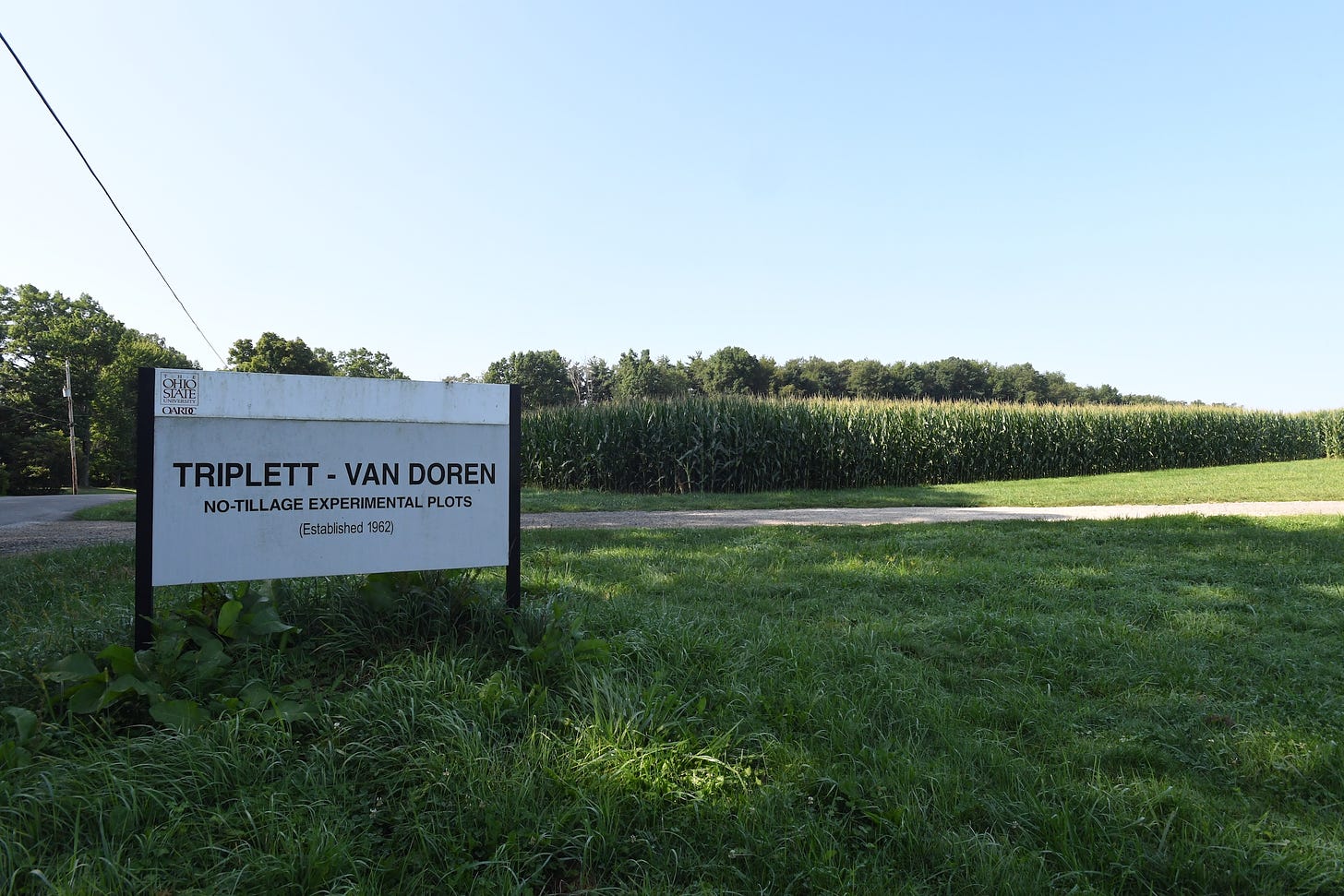 a sign near a field that says Triplett-Van Doren No Tillage Experimental Plots, Established 1961