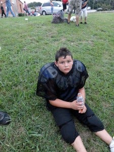 Young football player at rest