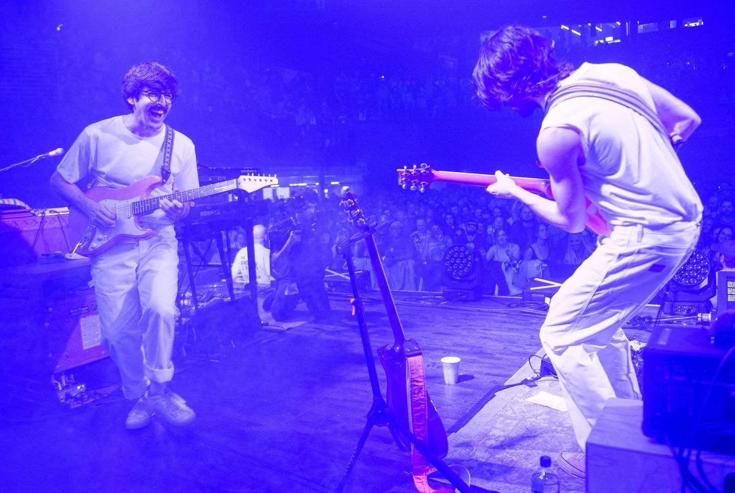 May be an image of 3 people, people standing, people playing musical instruments, guitar and indoor