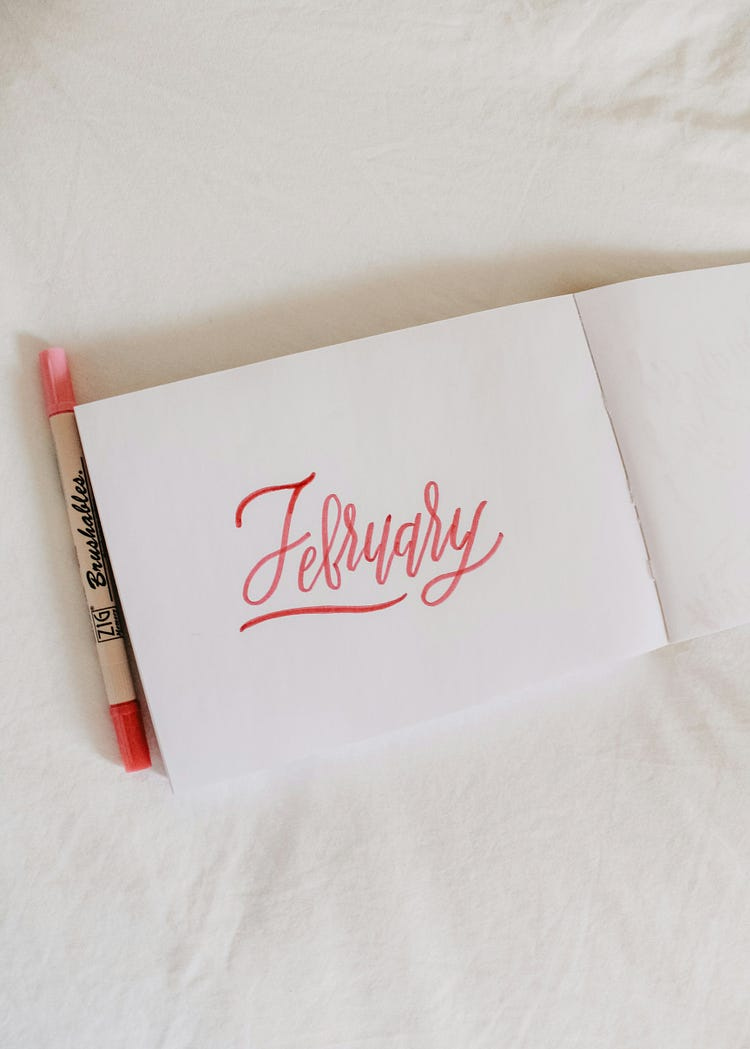 the word “February” written in red on white paper.