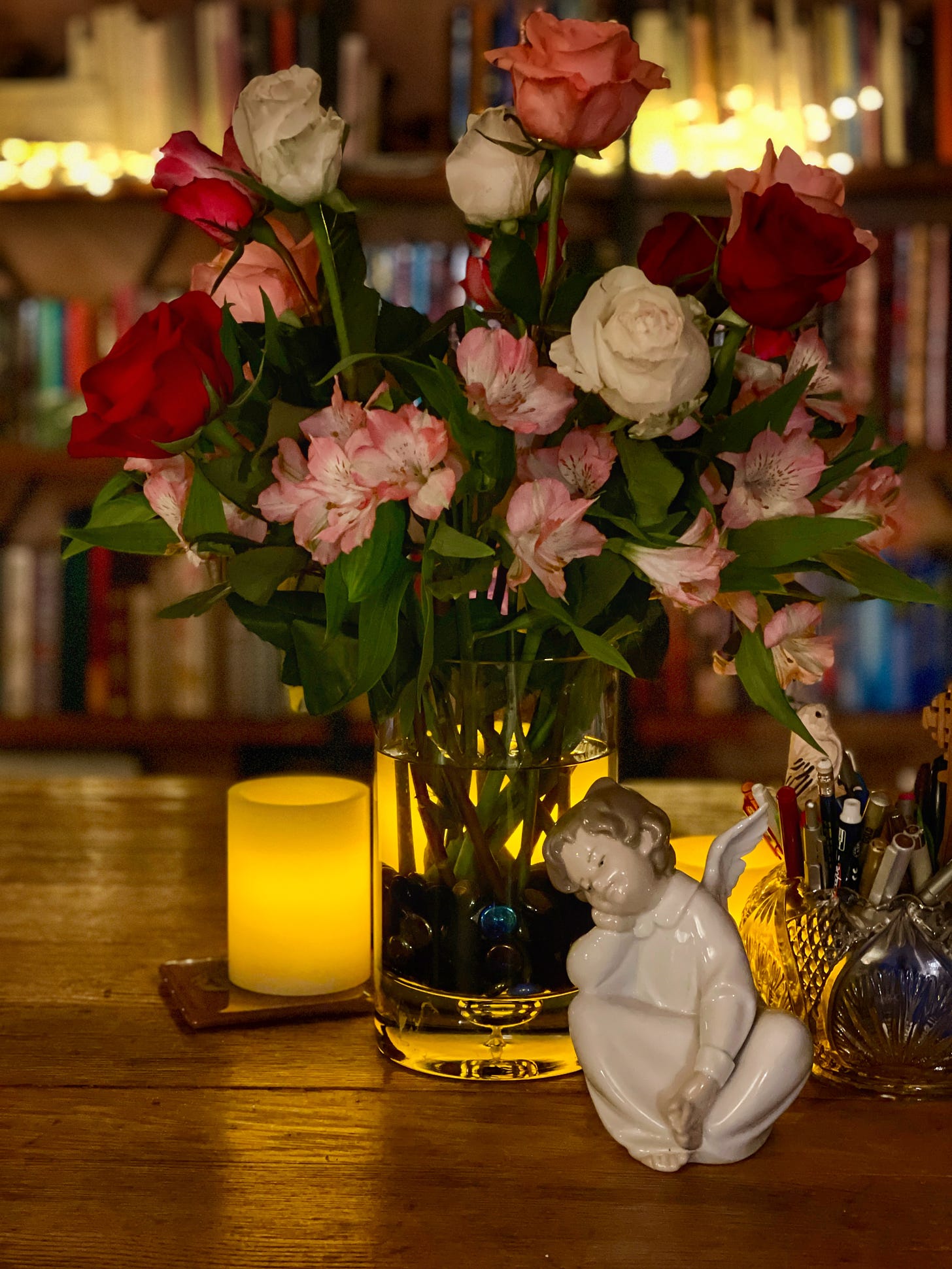 angel statue and flowers on table