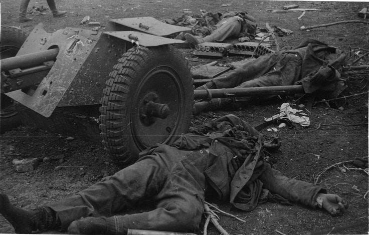 The bodies of dead soldiers sprawled on a battlefield.