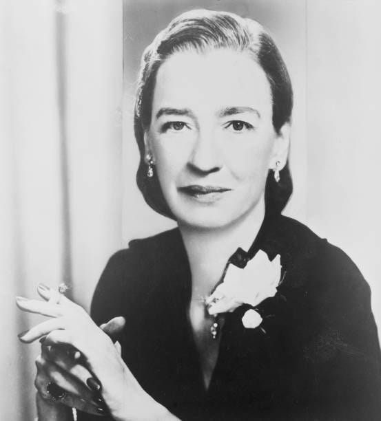 Portrait of Grace Hopper , pioneering computer programmer, seated facing front and smoking a cigarette, early 1960s.