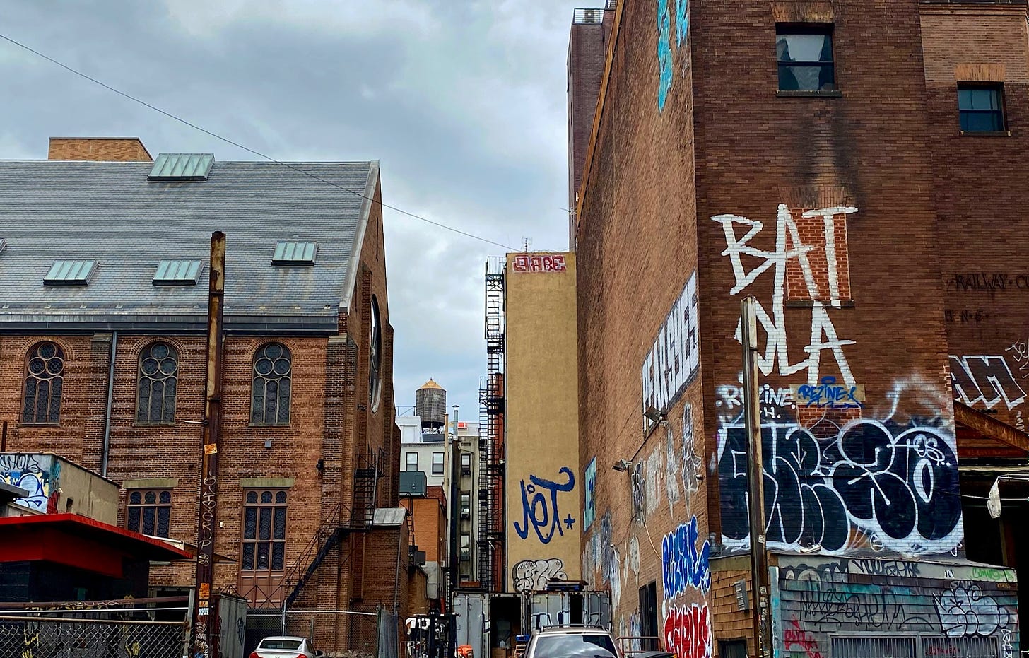 The back end of the Eldridge Street Synagogue and an old power station from an elevated train on either side of a water tower.