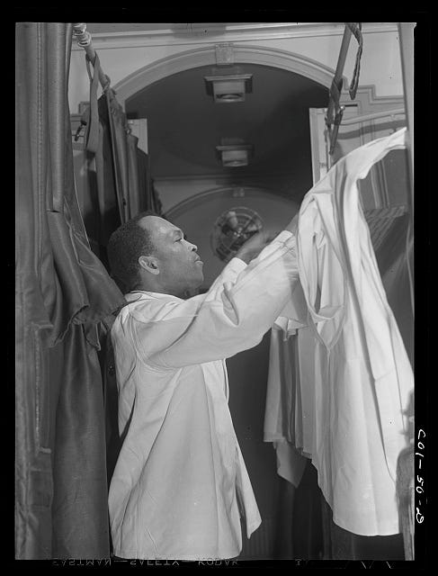 Pullman porter making up an upper berth aboard the "Capitol Limited" bound for Chicago, Illinois
