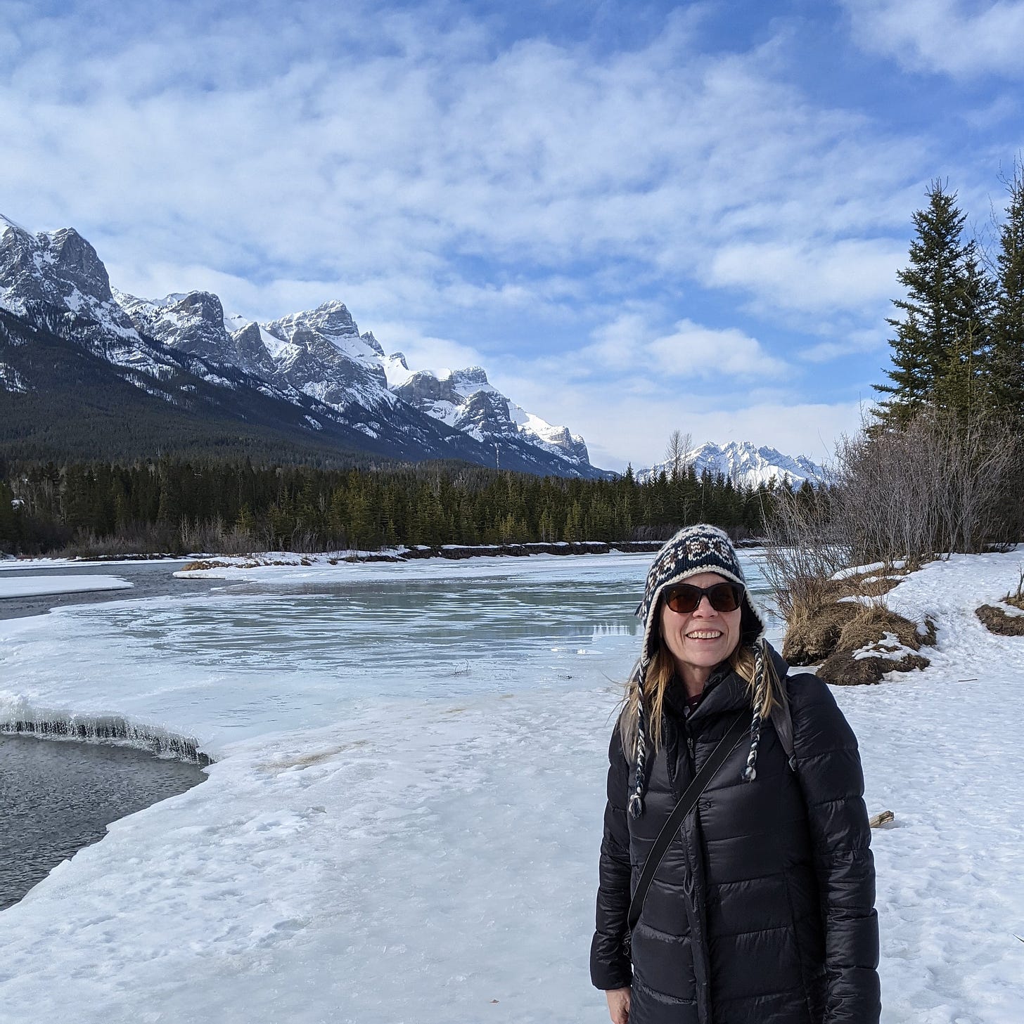Susan Moore hiking along the Bow River in Canmore Alberta in winter.