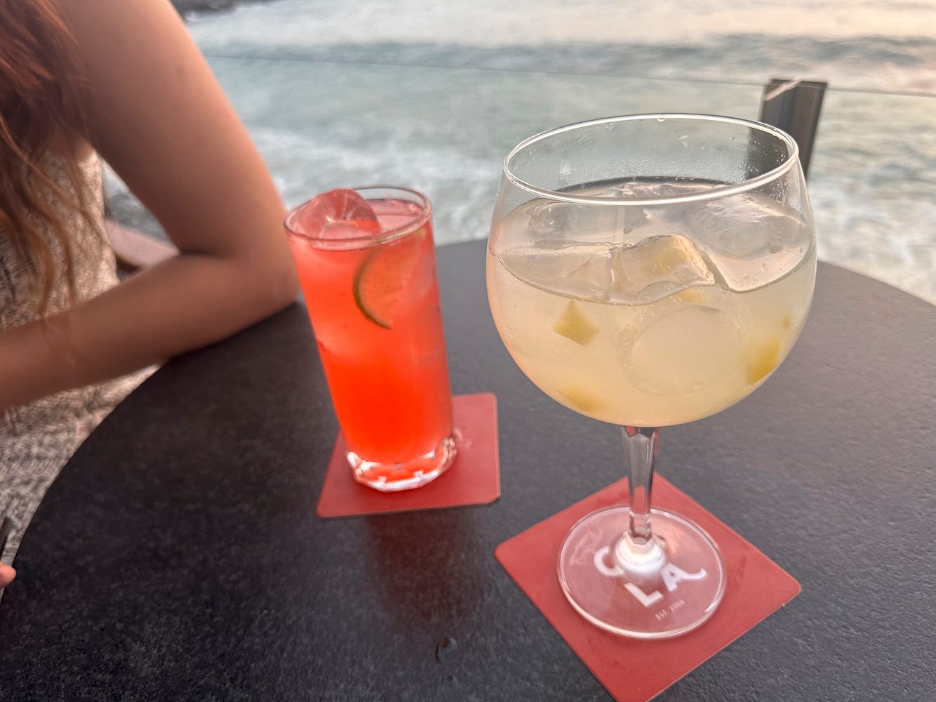 Gin and Pisco cocktails with a view of the beach at Cala