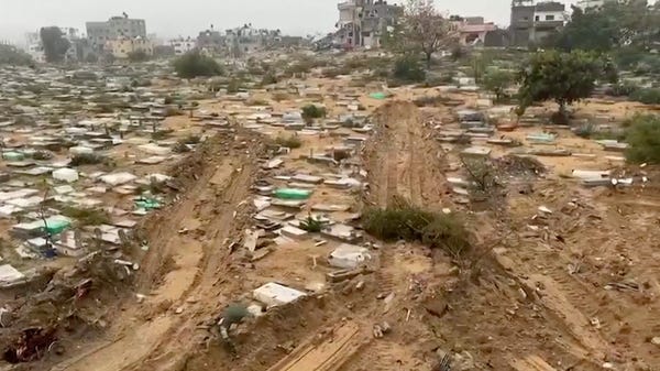A still frame from a video showing vehicle tracks leading into a cemetery in Gaza, with visible destruction of graves along the path.