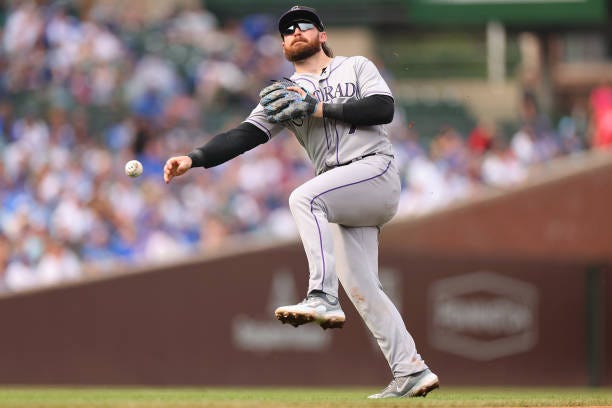 Brendan Rodgers of the Colorado Rockies throws a out a runner at first base during the fourth inning against the Chicago Cubs at Wrigley Field on...