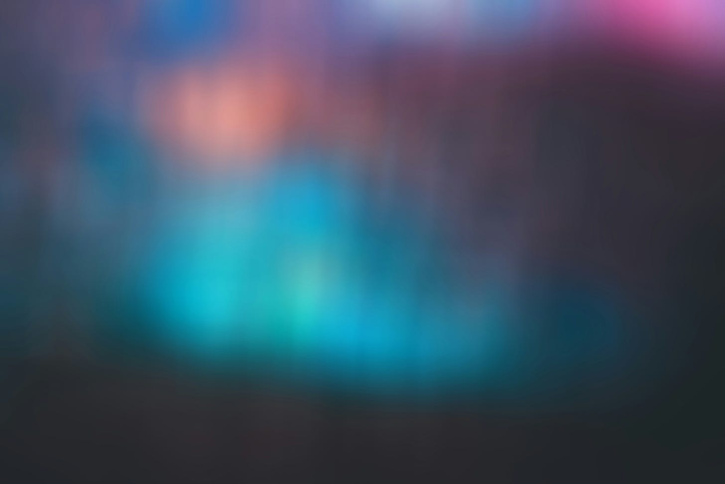 A blurry, smeary abstract photograph of dancing colors and patches of darkness.