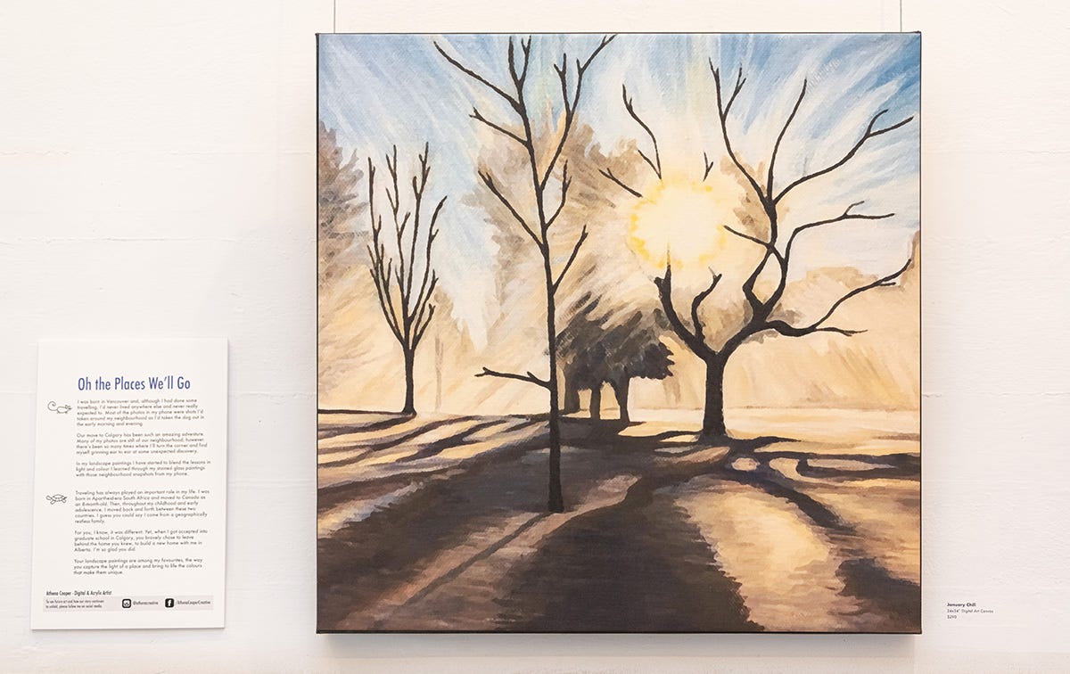 Large canvas hanging in gallery space depicting bare winter trees backlit by the warm glow of the rising sun. Long shadows cast from the trees stretch towards the viewer.