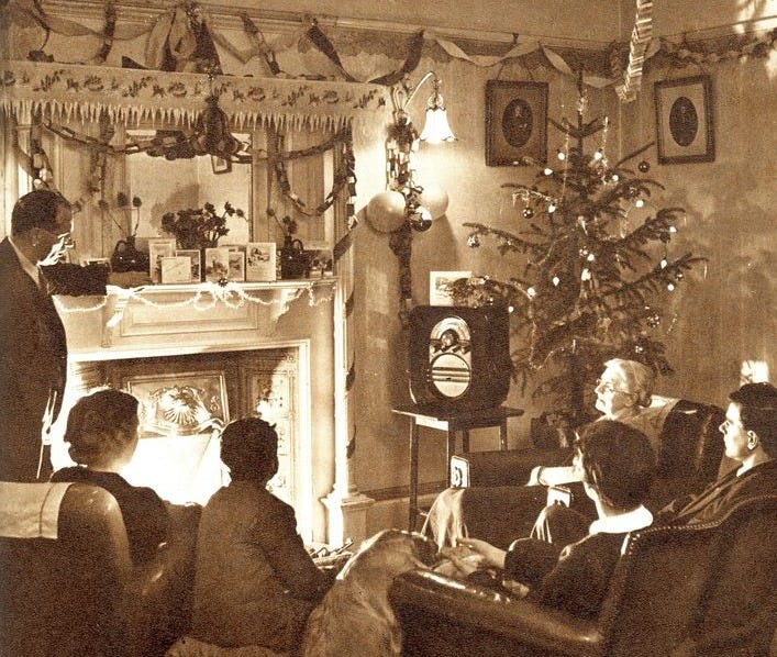 This may contain: an old black and white photo of people in a living room with a christmas tree