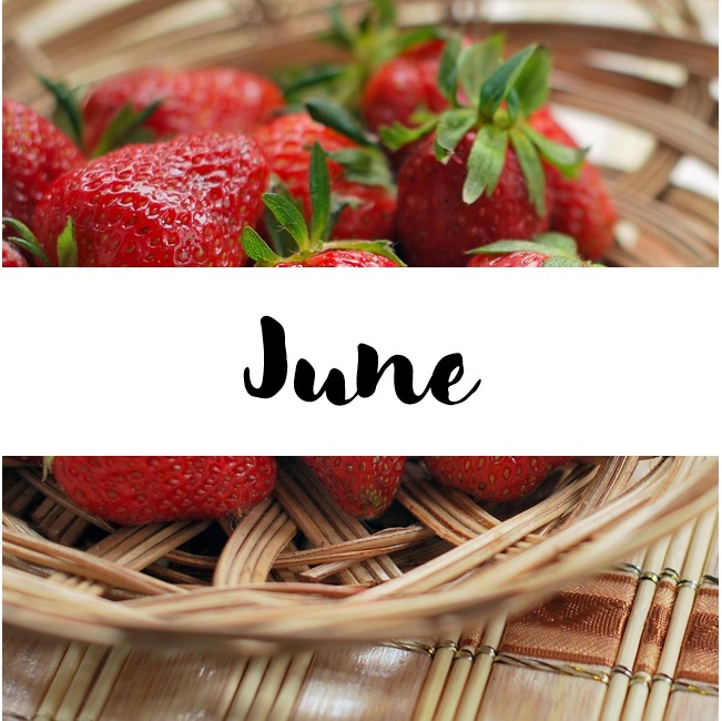 A basket of strawberries. In a white ribbon, the text reads "JUNE".