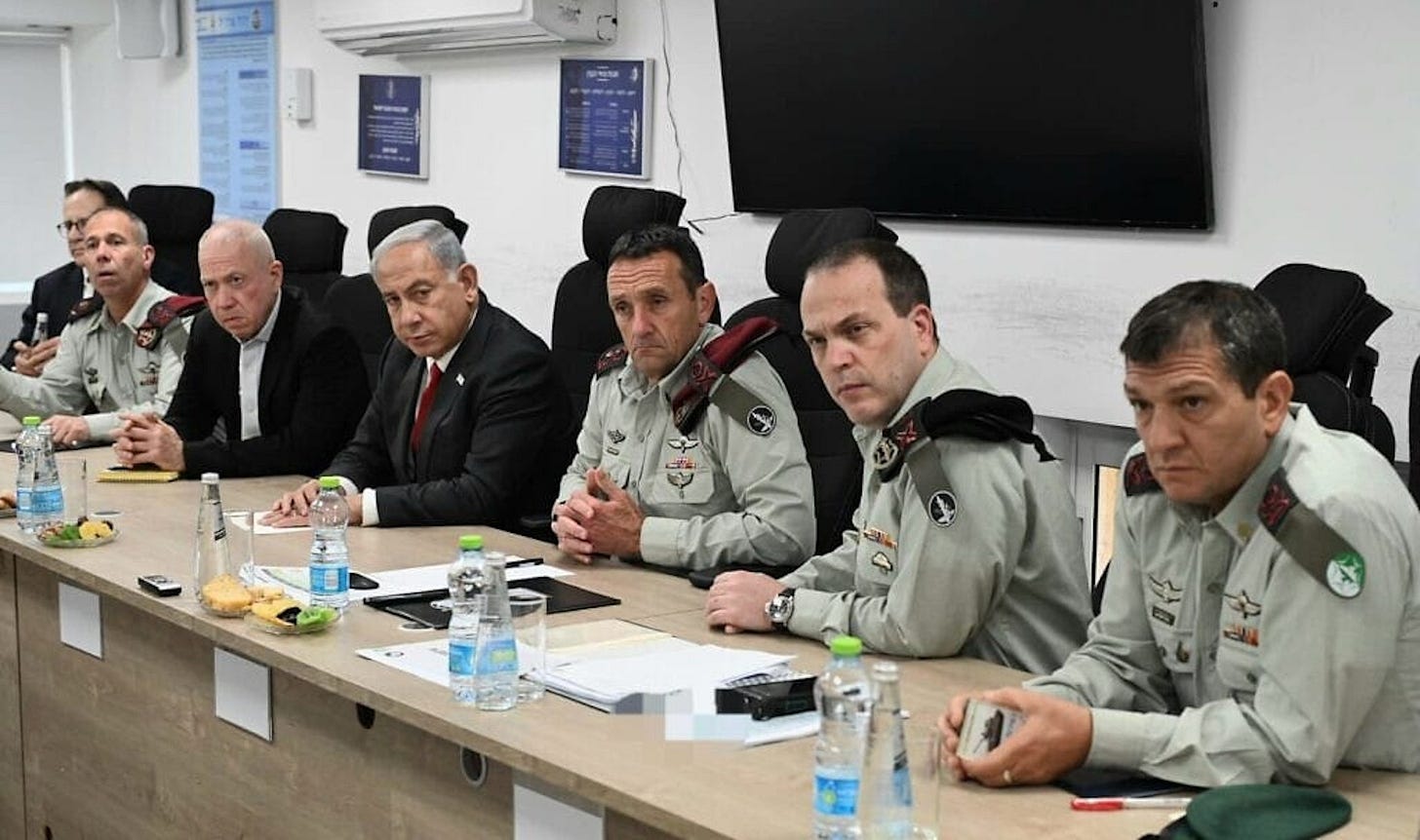 Israeli government and military officials, including Benjamin Netanyahu, Yoav Gallant and Oded Basyuk, sit at a conference table.