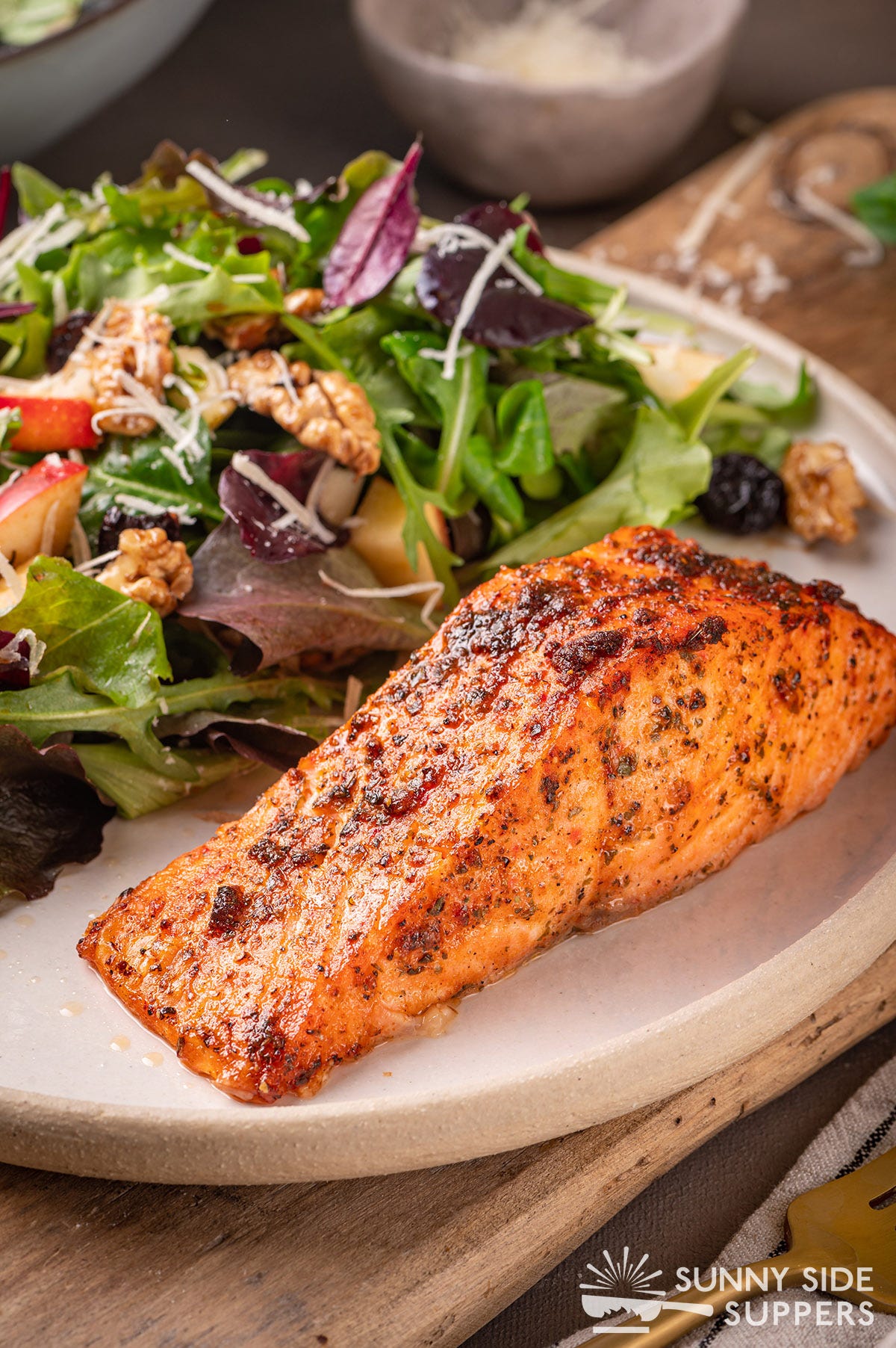 Air fryer salmon on a plate with salad.