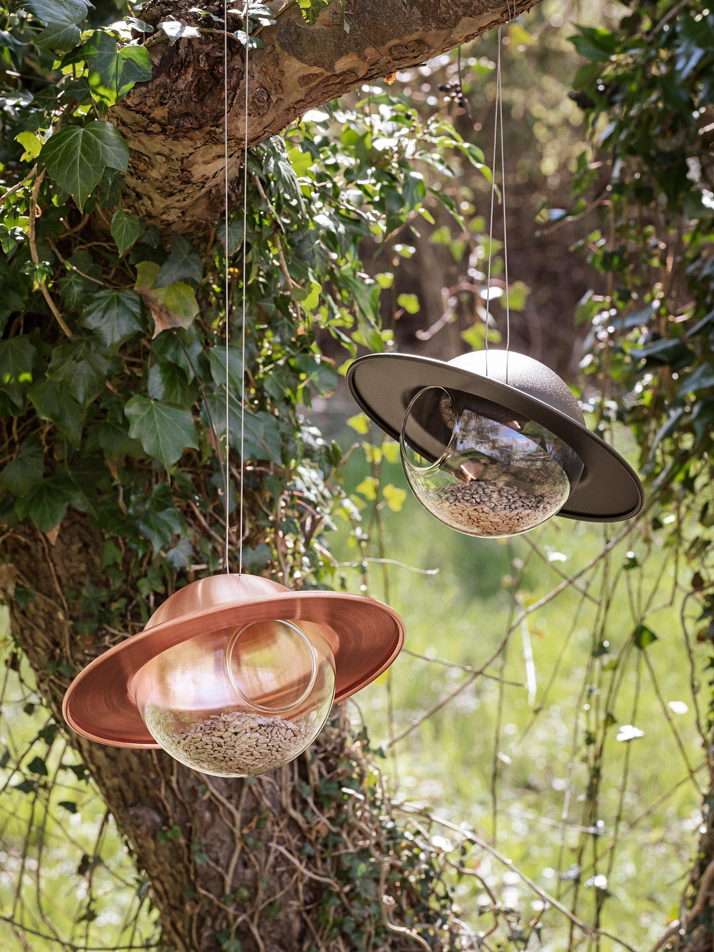 orb shaped bird feeder with copper decorative canopy