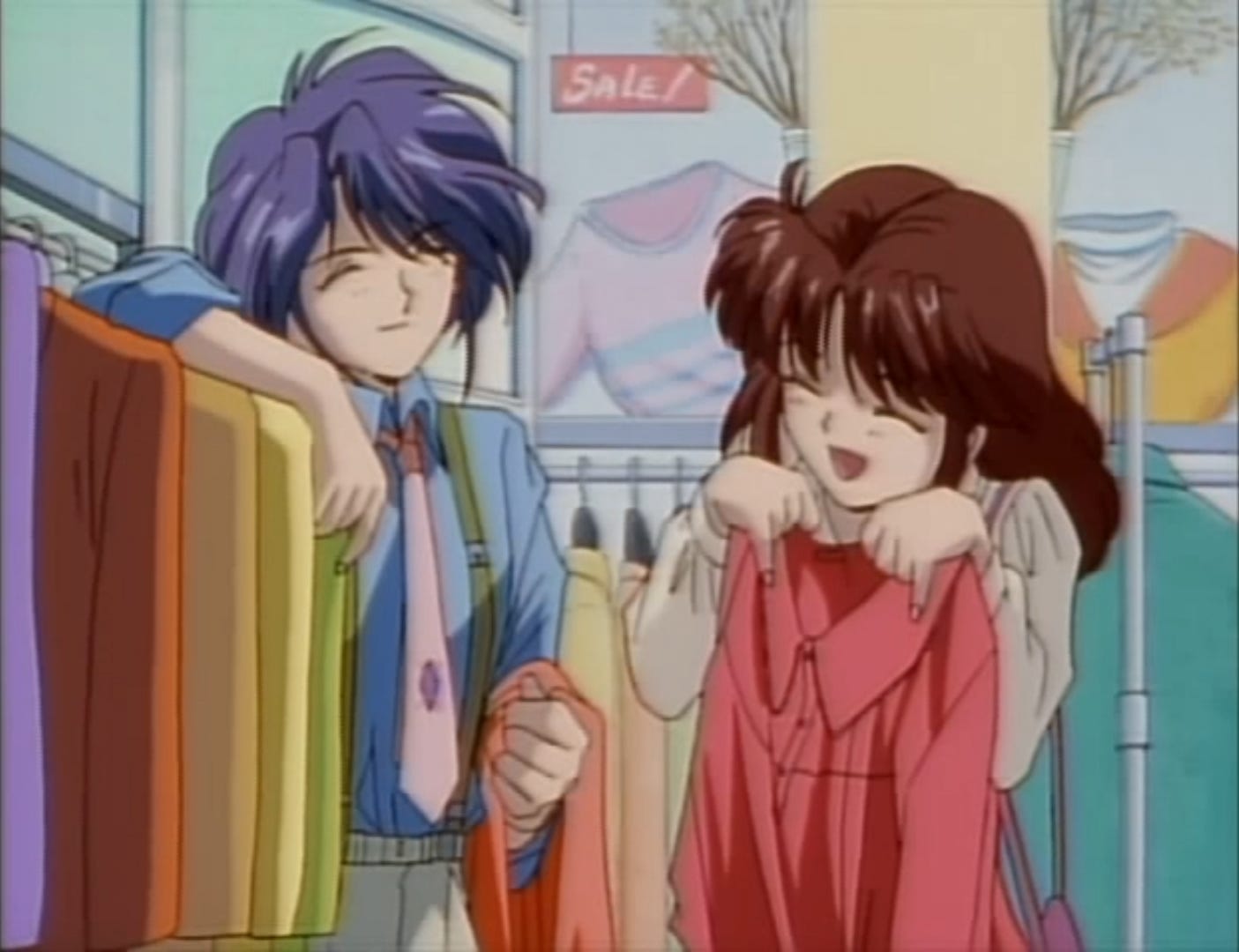 Nuriko with short cropped hair, blue dress shirt, green suspenders, and pink tie clothes shopping with Miaka, who is holding up a pink blouse, in the "real world"