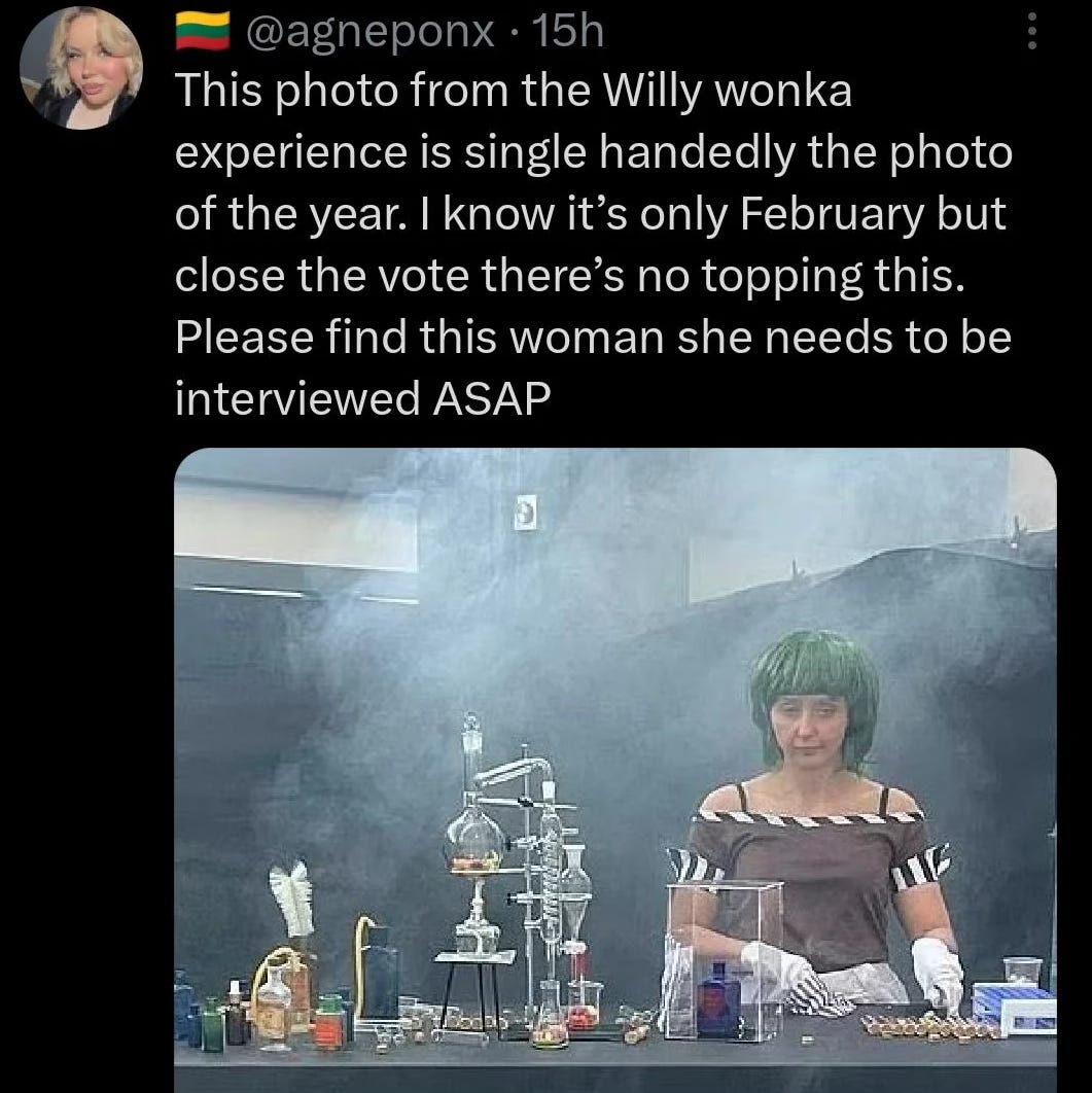 a tweet from a user called @agneponx which says: this photo from the willy wonka experience is single-handedly the photo of the year. i know it's only february but close the vote there's no topping this please find this woman she needs to be interviewed asap. and the picture below it shows a woman from the willy wonka experience in Glasgow. she is wearing a green week has something approaching a fake tan a brown dress with striped hem and is standing behind what looks like cheap laboratory equipment. she is pretending to conduct an experiment or make confectionery, when actually she is just taking fruit pastilles out of the packet