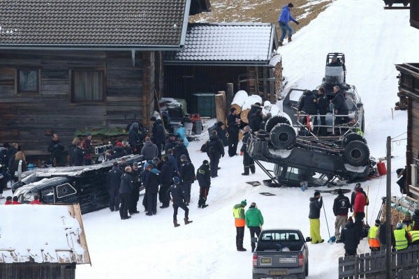 daniel craig running to overturned car in spectre movie