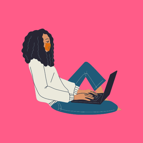 A woman with curly Black hair wearing a face mask, a white jumper, and blue jeans is sitting on the floor with a black laptop open on her lap.