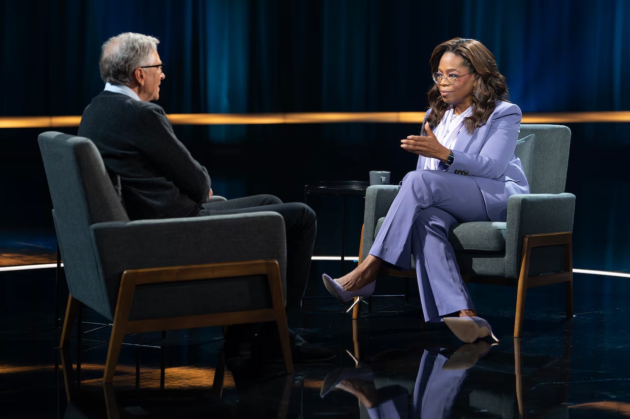 Bill Gates across from Oprah Winfrey in an interview.