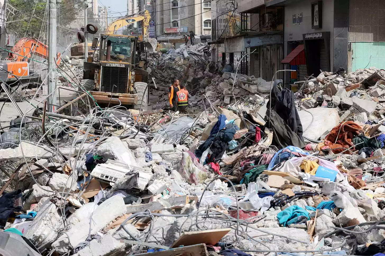 An excavator clears the rubble of a destroyed building in Gaza City's Rimal residential district on May 16, 2021