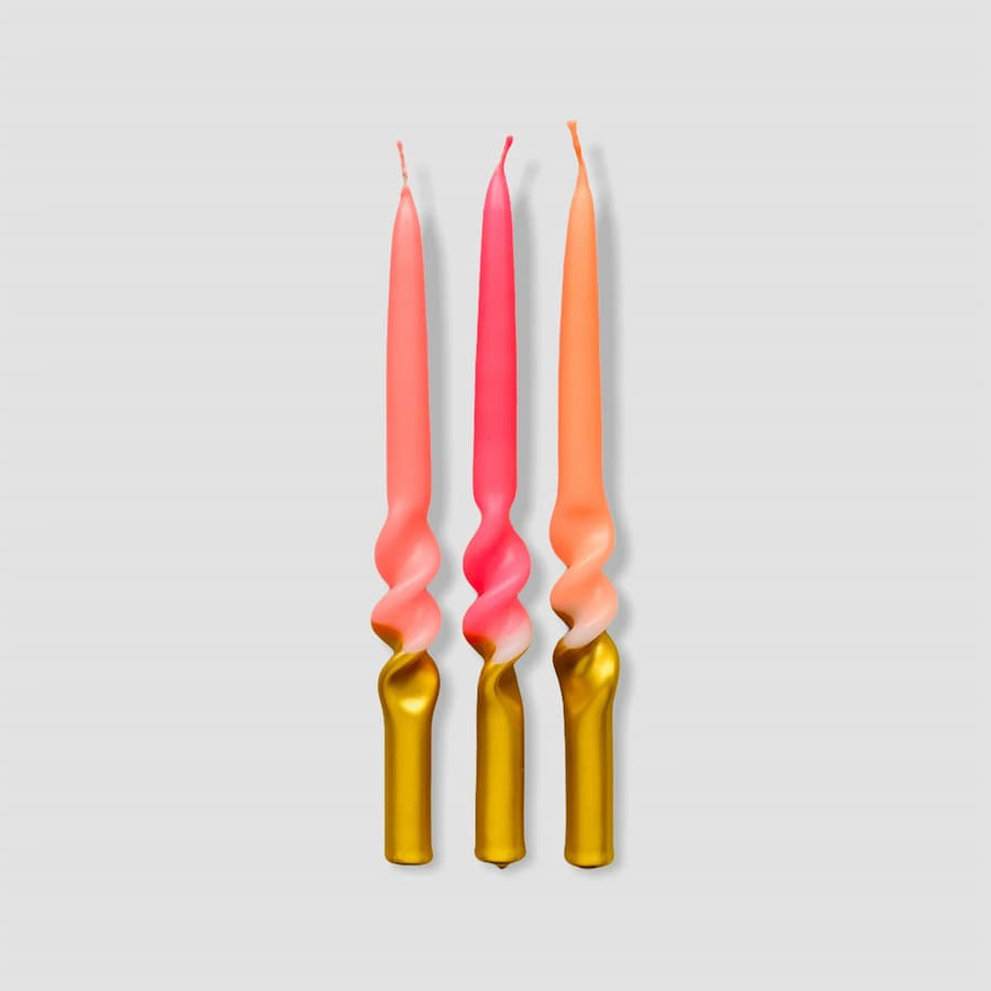 Pack of three luxury dip-dye candles in bright colours of pink and peach, with a twist at the lower part of the candle