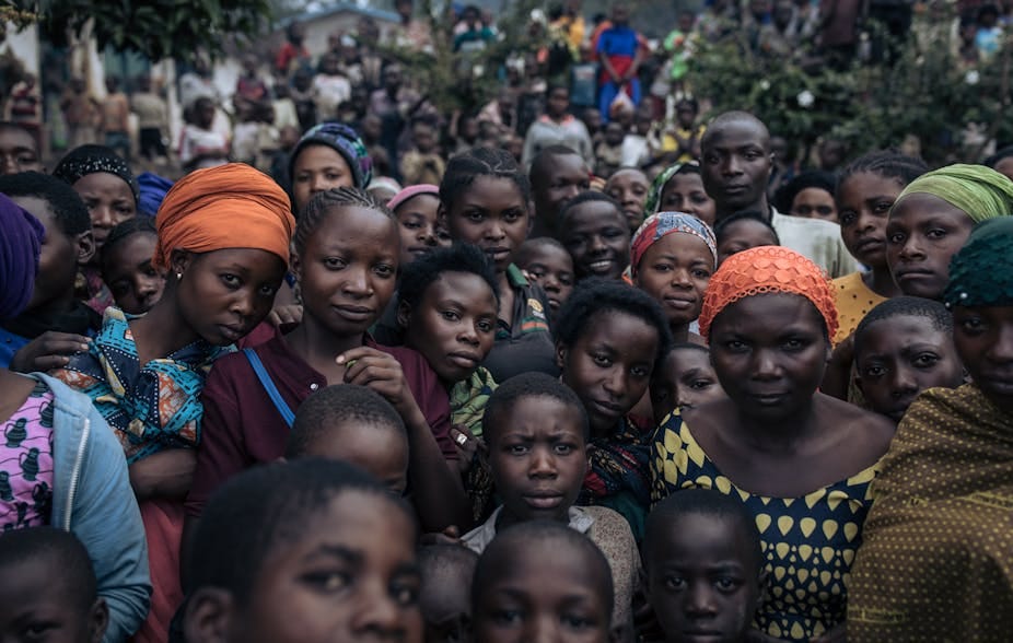 Dozens of displaced people in estearn DRC pose for the camera.