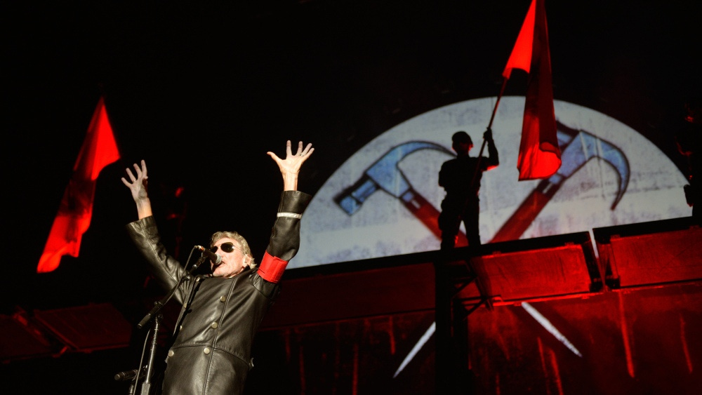 British musician and founding member of Pink Floyd, Roger Waters performs on stage during his "The Wall" show at the Olympic stadium in Berlin on September 4, 2013 AFP PHOTO / ODD ANDERSEN        (Photo credit should read ODD ANDERSEN/AFP via Getty Images)