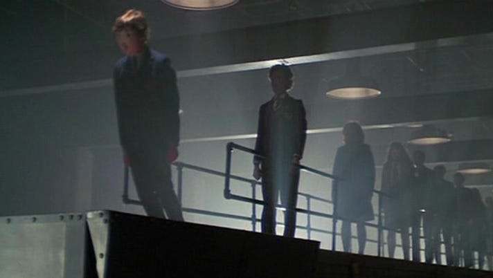 Screenshot from 'Another Brick In The Wall' in 'The Wall' movie, showing students marching into the meat grinder.