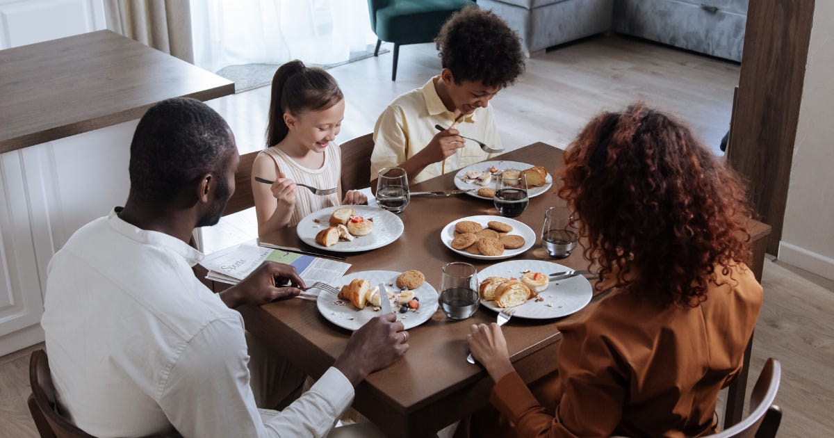 A family of four sits down to a meal together. There's an analogy in this essay that relates to the image.