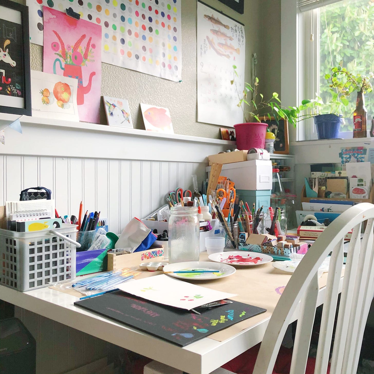 a studio table filled with art supplies